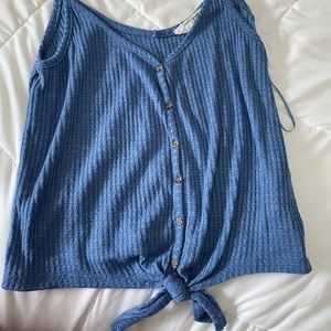 A blue button up tie shirt.